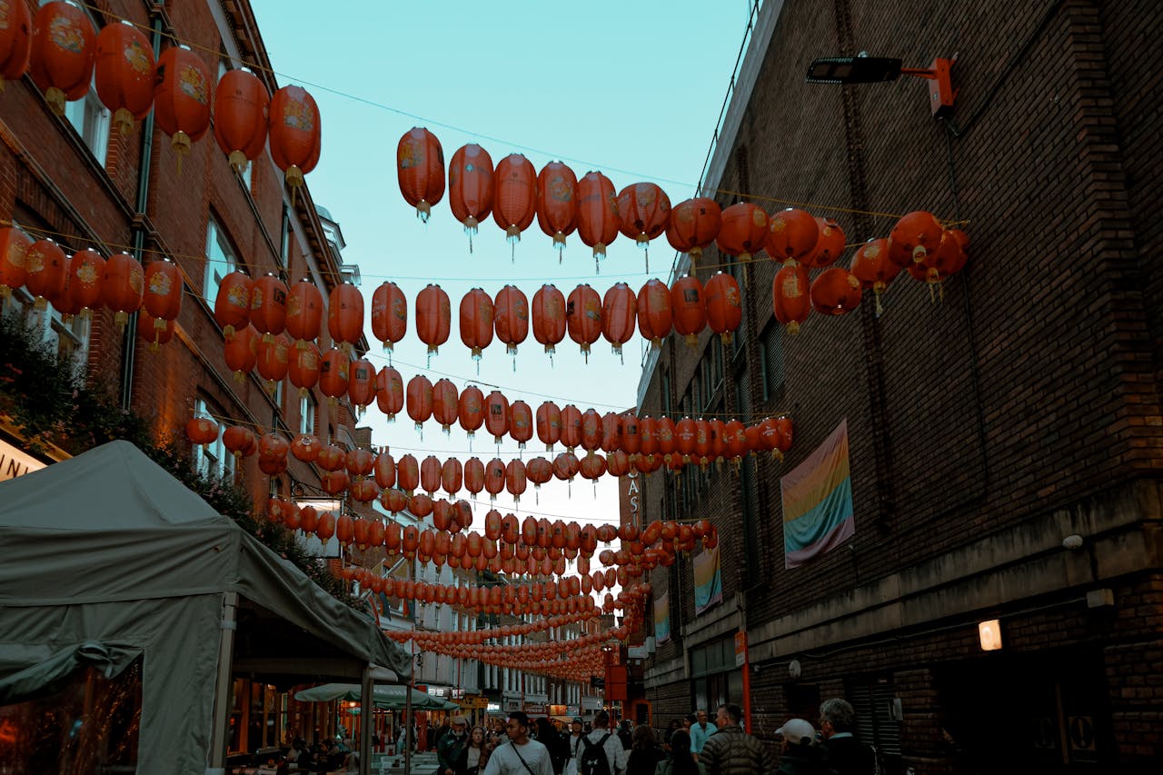 Colorful Chinese lanterns adorn London's Chinatown street at twilight, enhancing the cultural atmosphere.